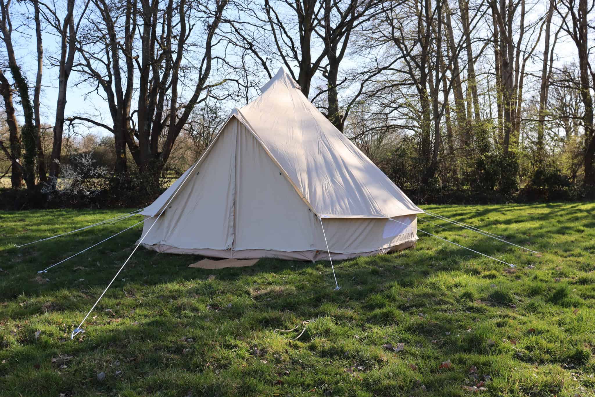 Bell-tent-with-trees-in-the-back-ground-sunny-day